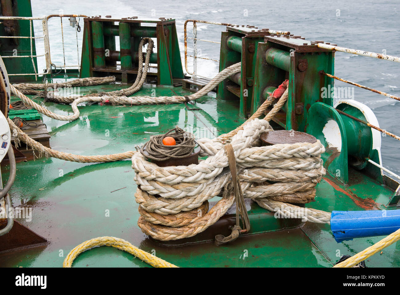 Ship ropes folded on a ship in straps Stock Photo - Alamy