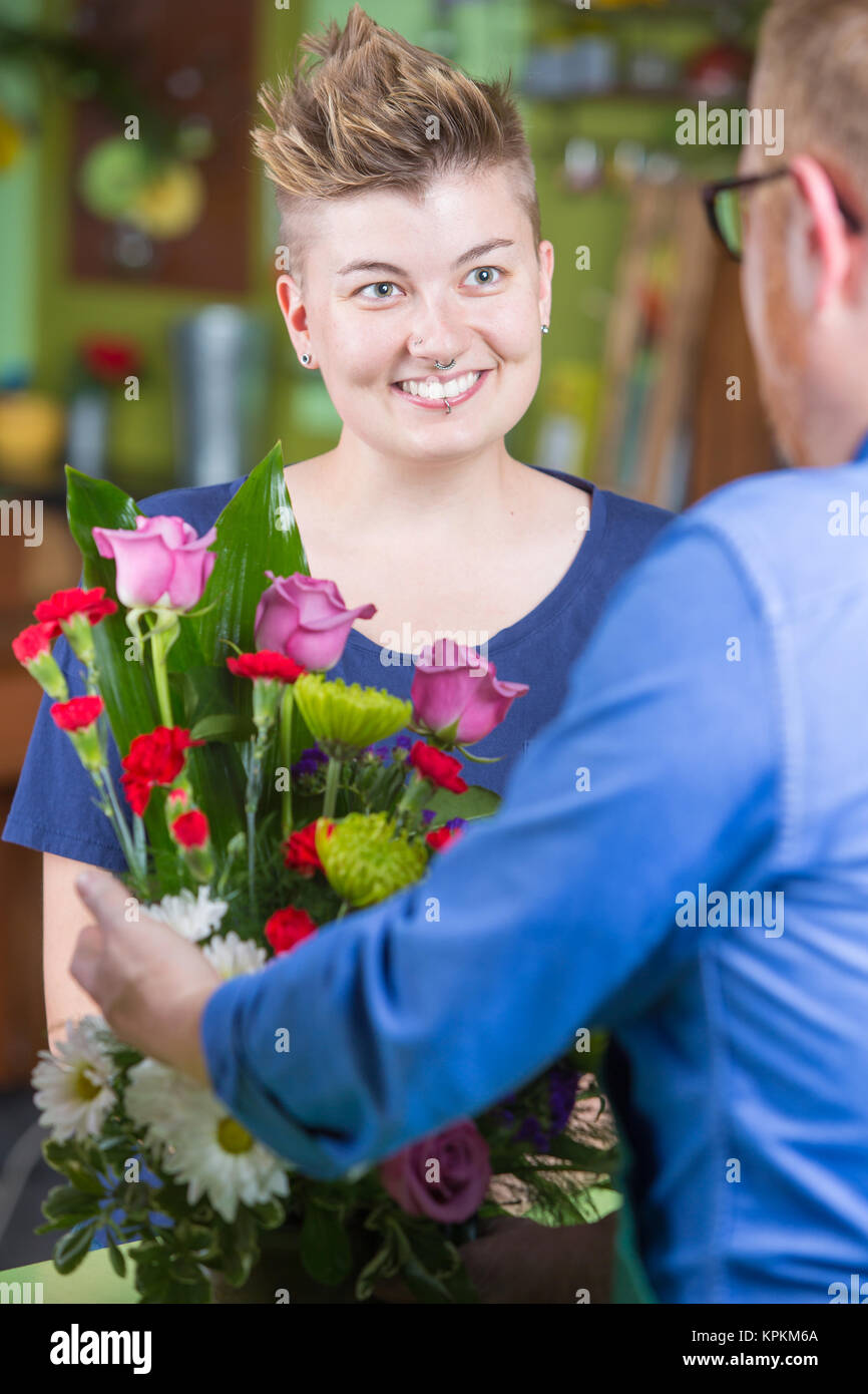 Attractive Woman in Flower Shop Purchases Arrangement Stock Photo - Alamy
