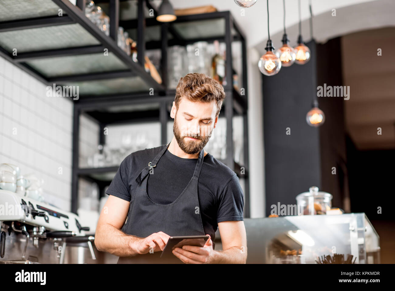 Waiter with tablet at the cafe Stock Photo