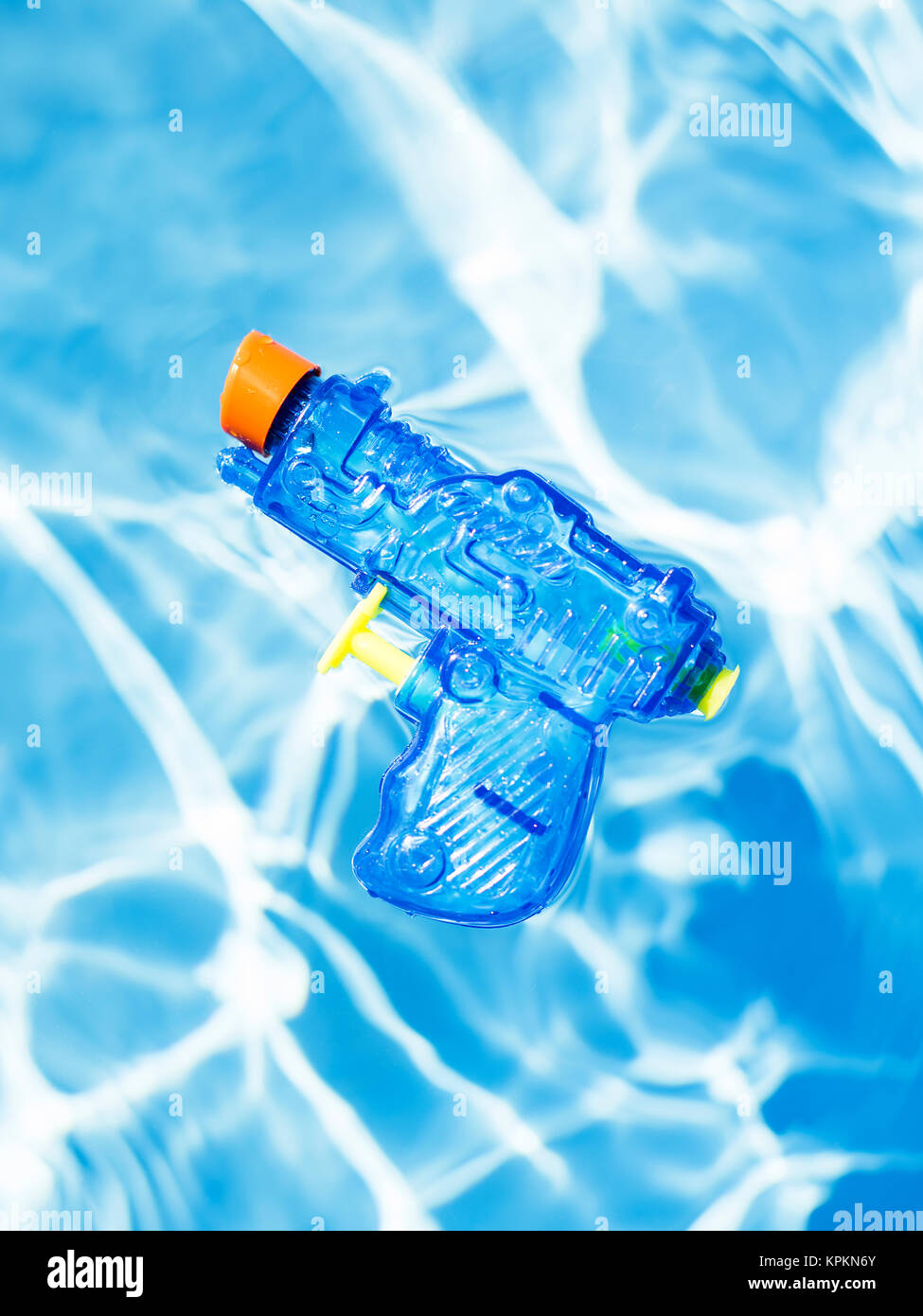 Blue squirt gun floating one water. Stock Photo