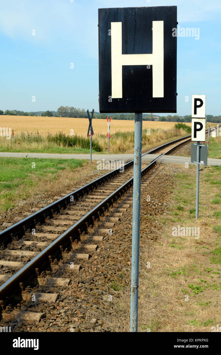 holding sign on a railway track Stock Photo