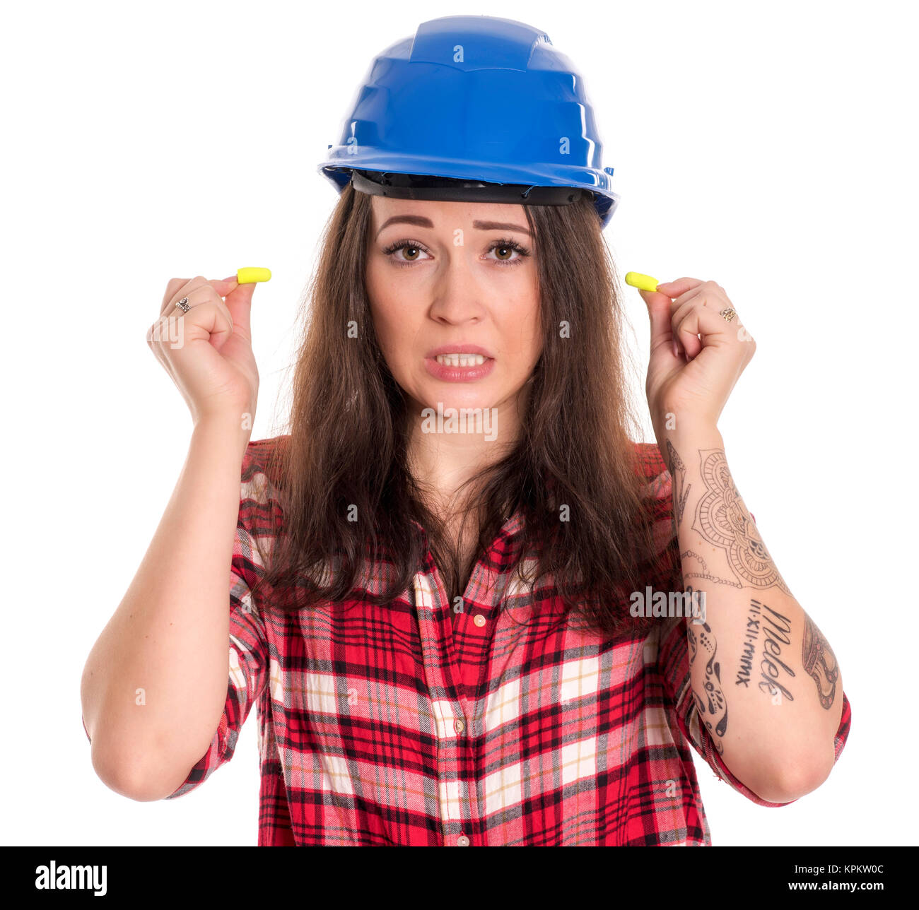 craftsmen with safety helmet ear plugs inserted in the ears Stock Photo