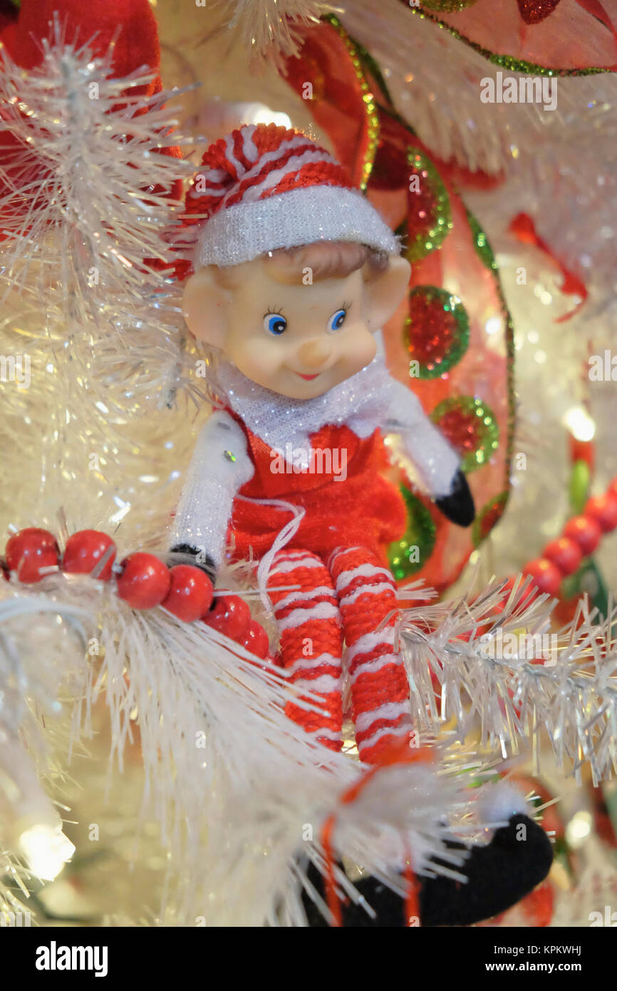 Small toy elf is used as a Christmas tree decoration or ornament during the christian holiday season. Stock Photo