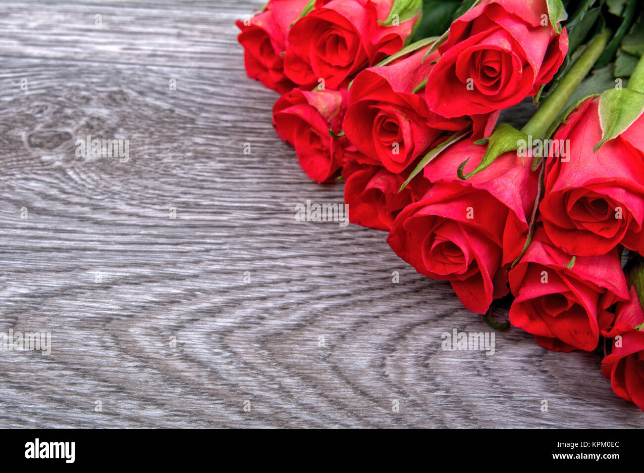 Red roses on a wooden background Stock Photo - Alamy