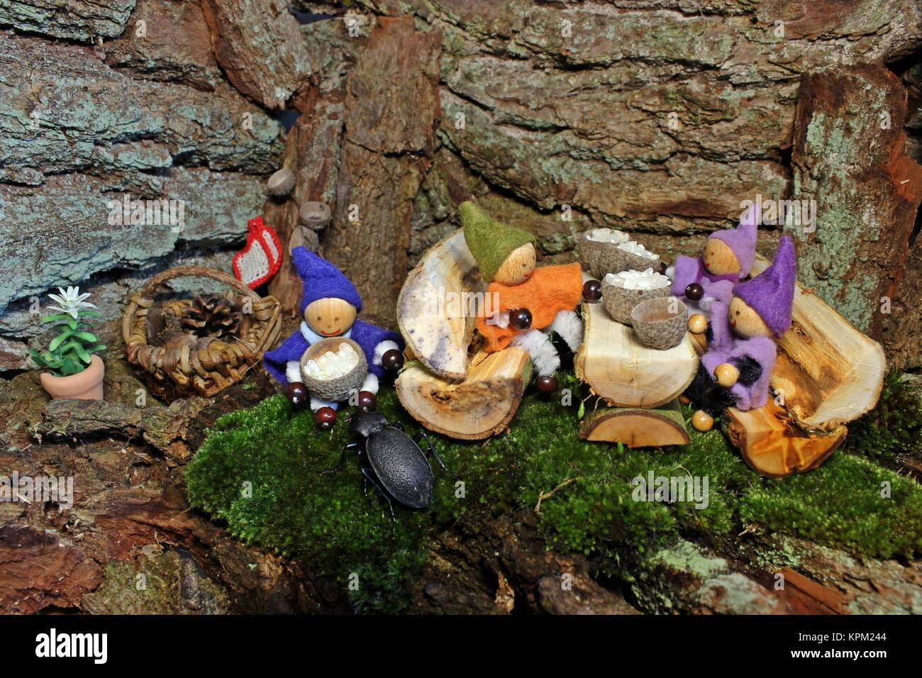 four little gnomes eat rice Stock Photo