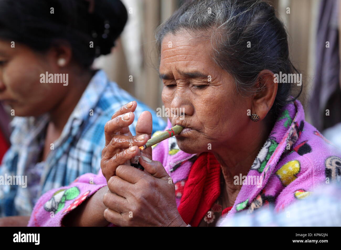 Old woman from Burma smoking cigars Stock Photo