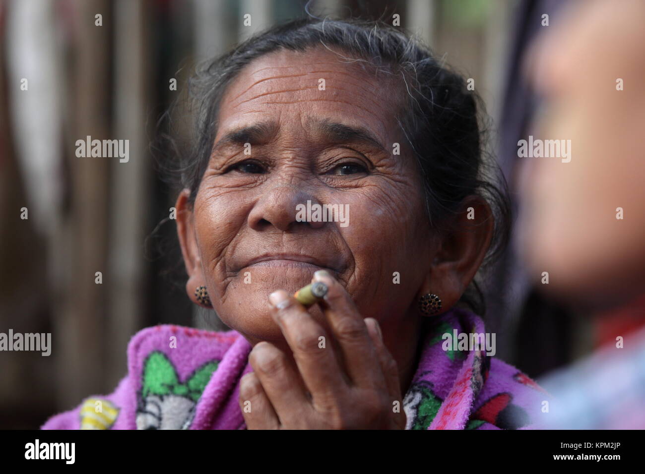 Old woman from Burma smoking cigars Stock Photo