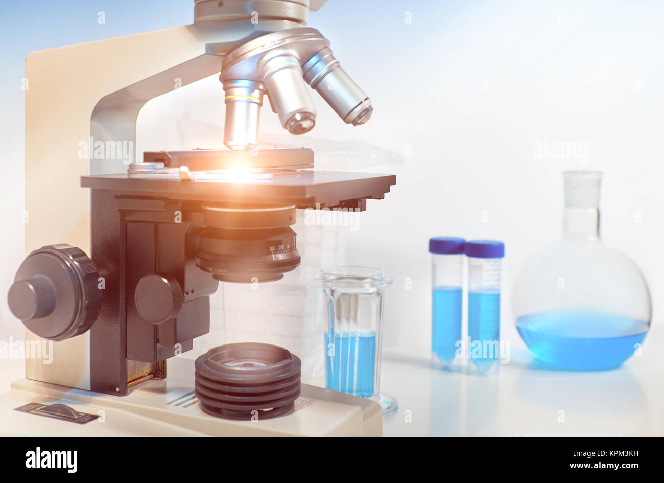 Scientific background with closeup on light microscope and laboratory ...
