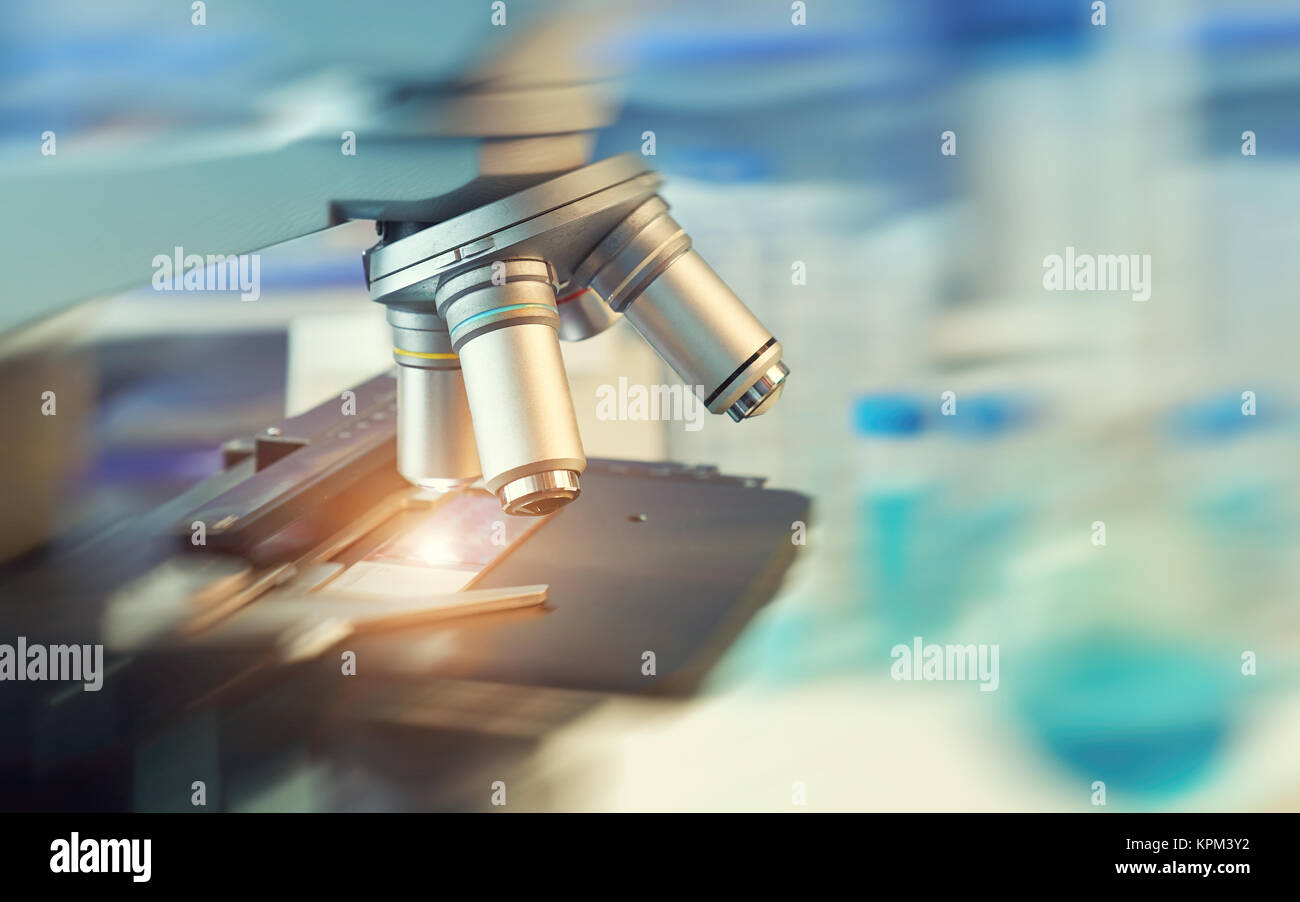 Scientific background with closeup on light microscope and laboratory ...