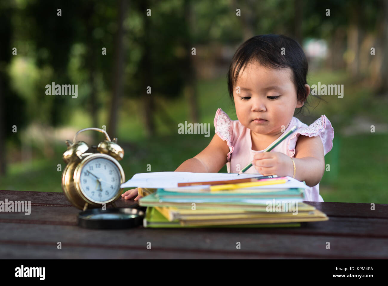 little baby toddler drawing using left hand at park. left handed concept Stock Photo
