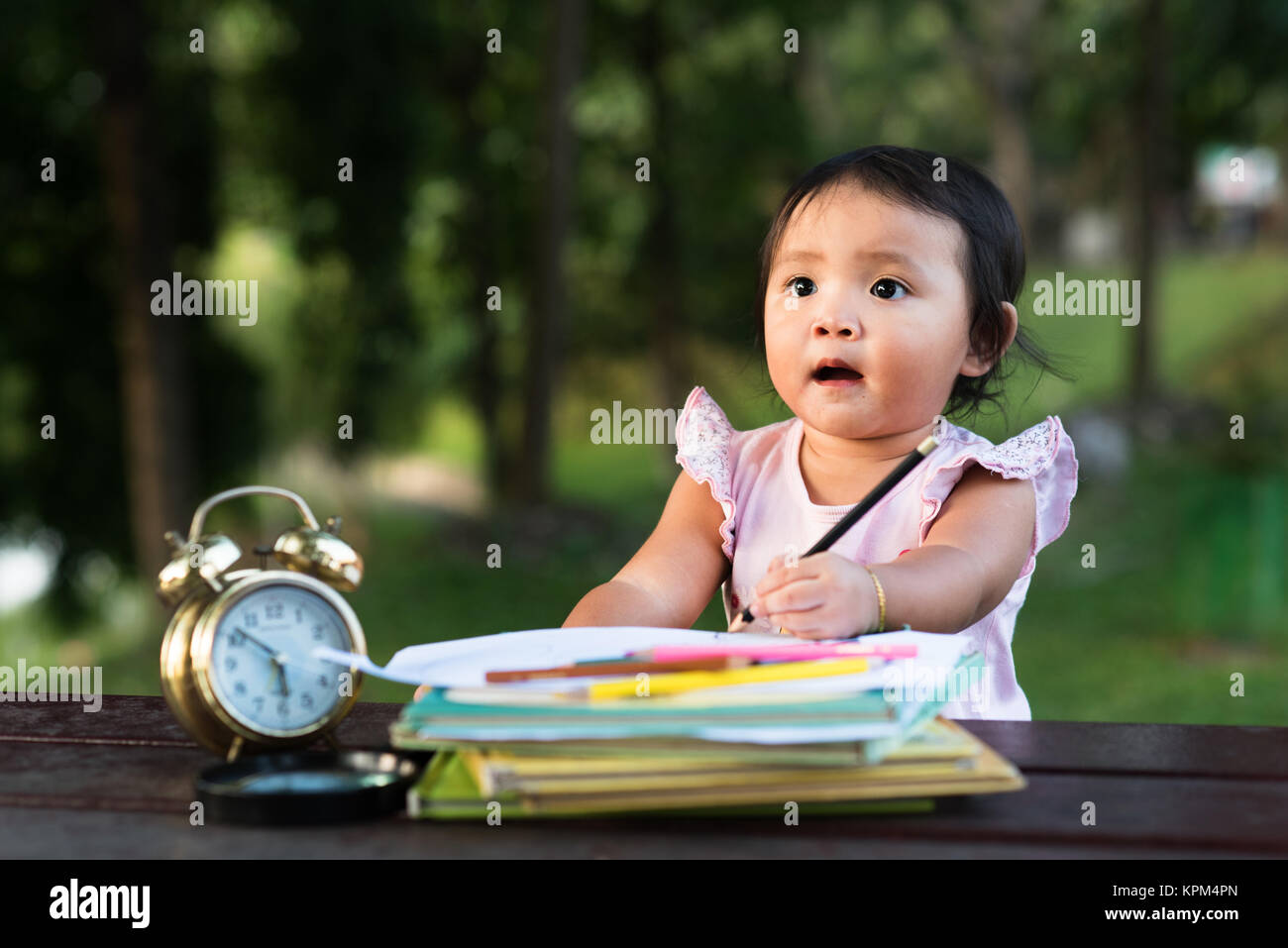 asian little baby toddler drawing at park while looking at empty space ( copy sace ). early ecucation concept. Stock Photo