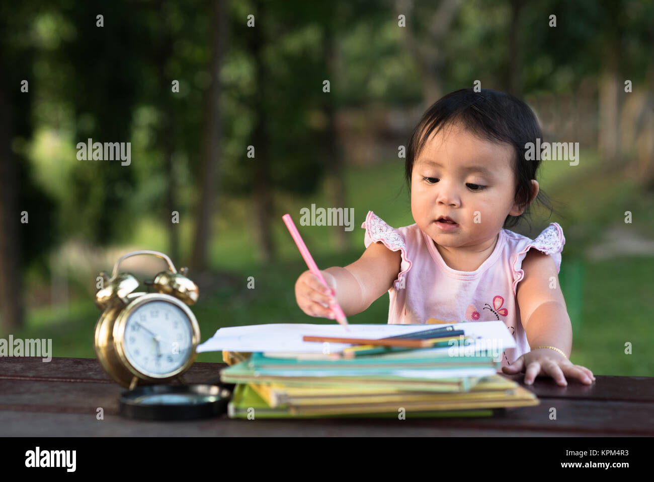 asian little baby toddler drawing at park with copy space. early ecucation concept. Stock Photo
