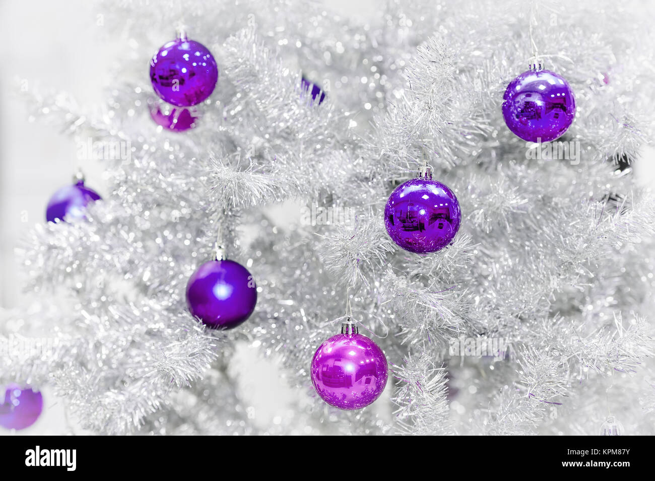 Decoration ultraviolet baubles on silver artificial Christmas tree Stock Photo