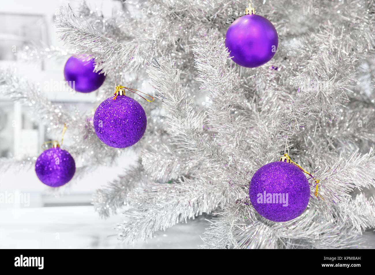 baubles ultraviolet on silver artificial Christmas tree Stock Photo