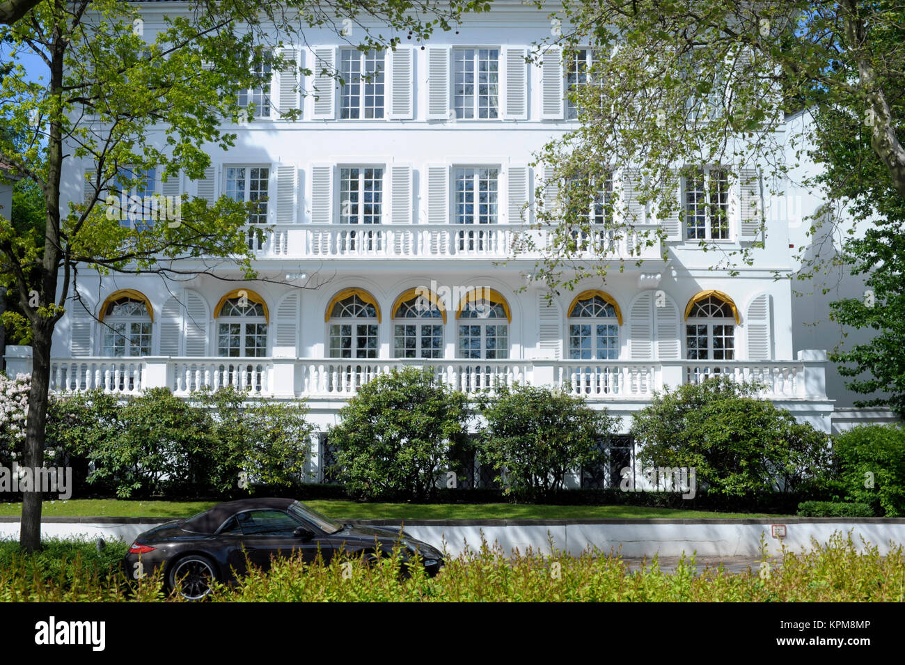Hamburg, one of the most beautiful and most popular tourist destinations in the world. Luxurious snow-white house with Porsche on the Alster. Stock Photo