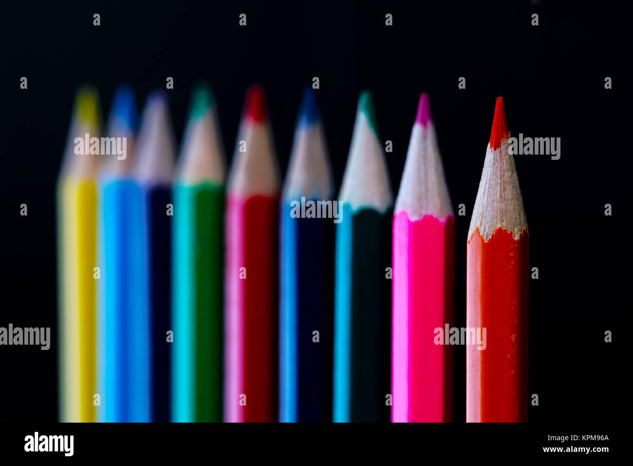 Collection of colored pencils on black background. Stock Photo