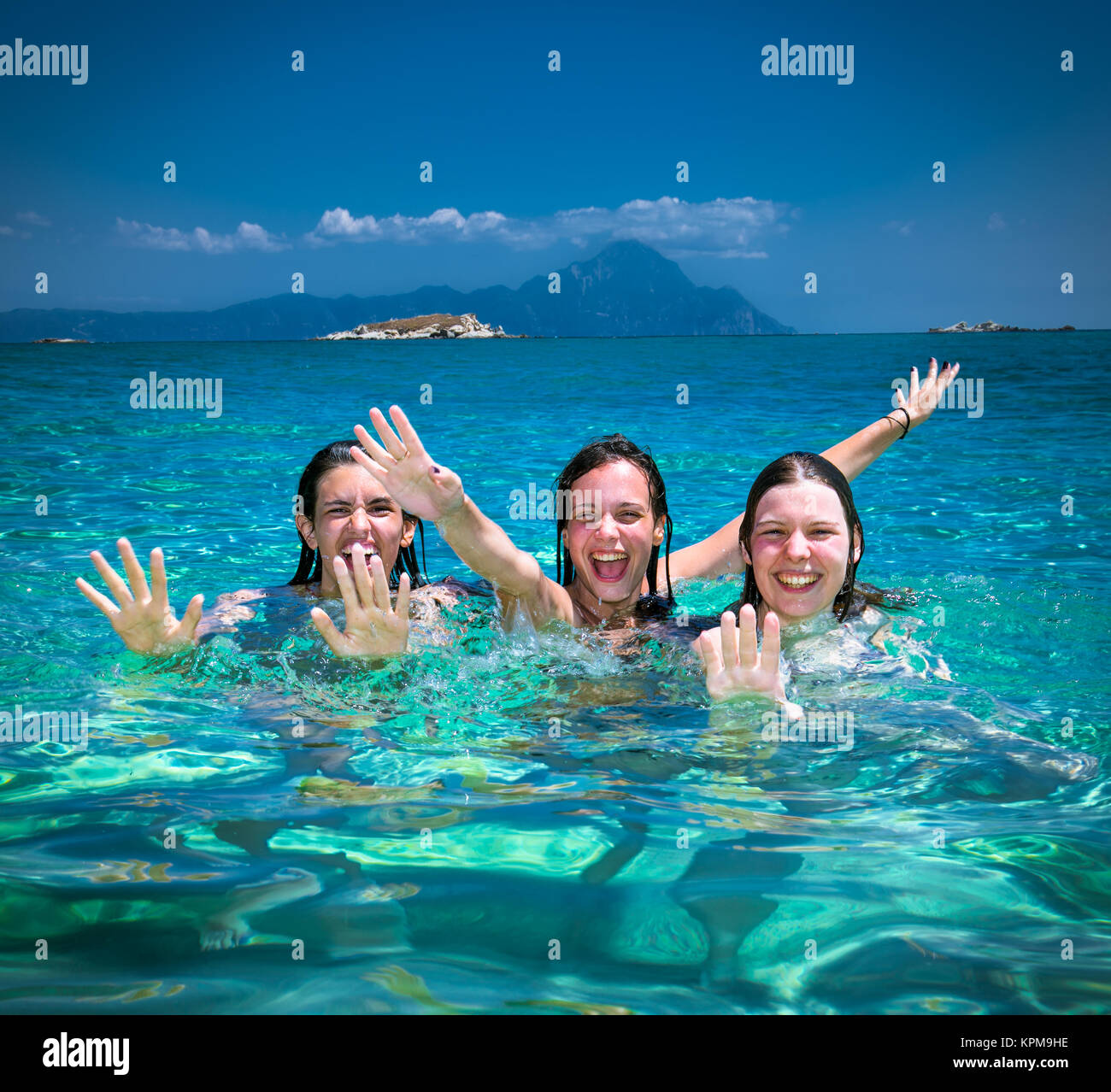 Three beautiful attractive young women having fan on the beach Stock Photo