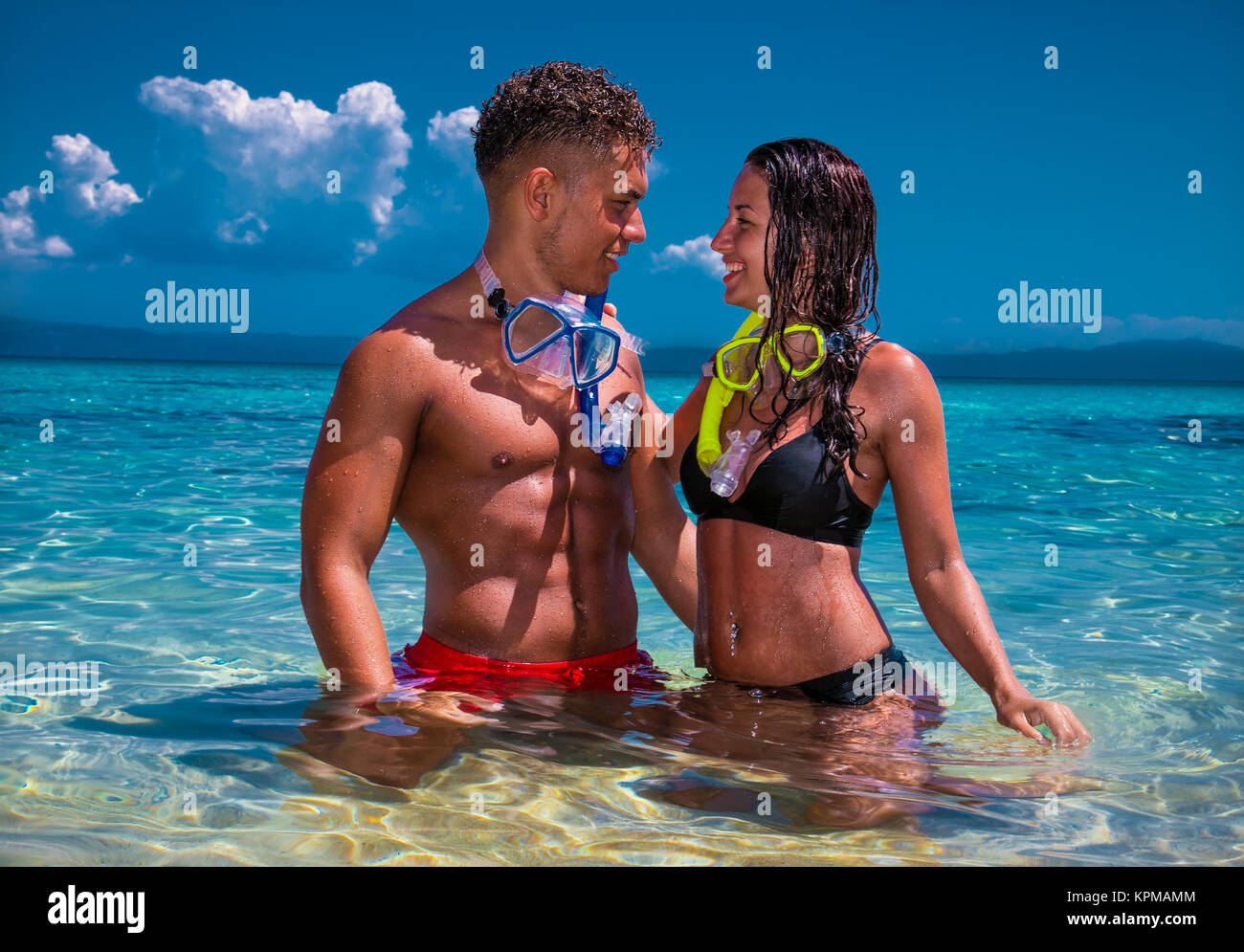 Beautiful couple in embrace on the beach in Greece Stock Photo