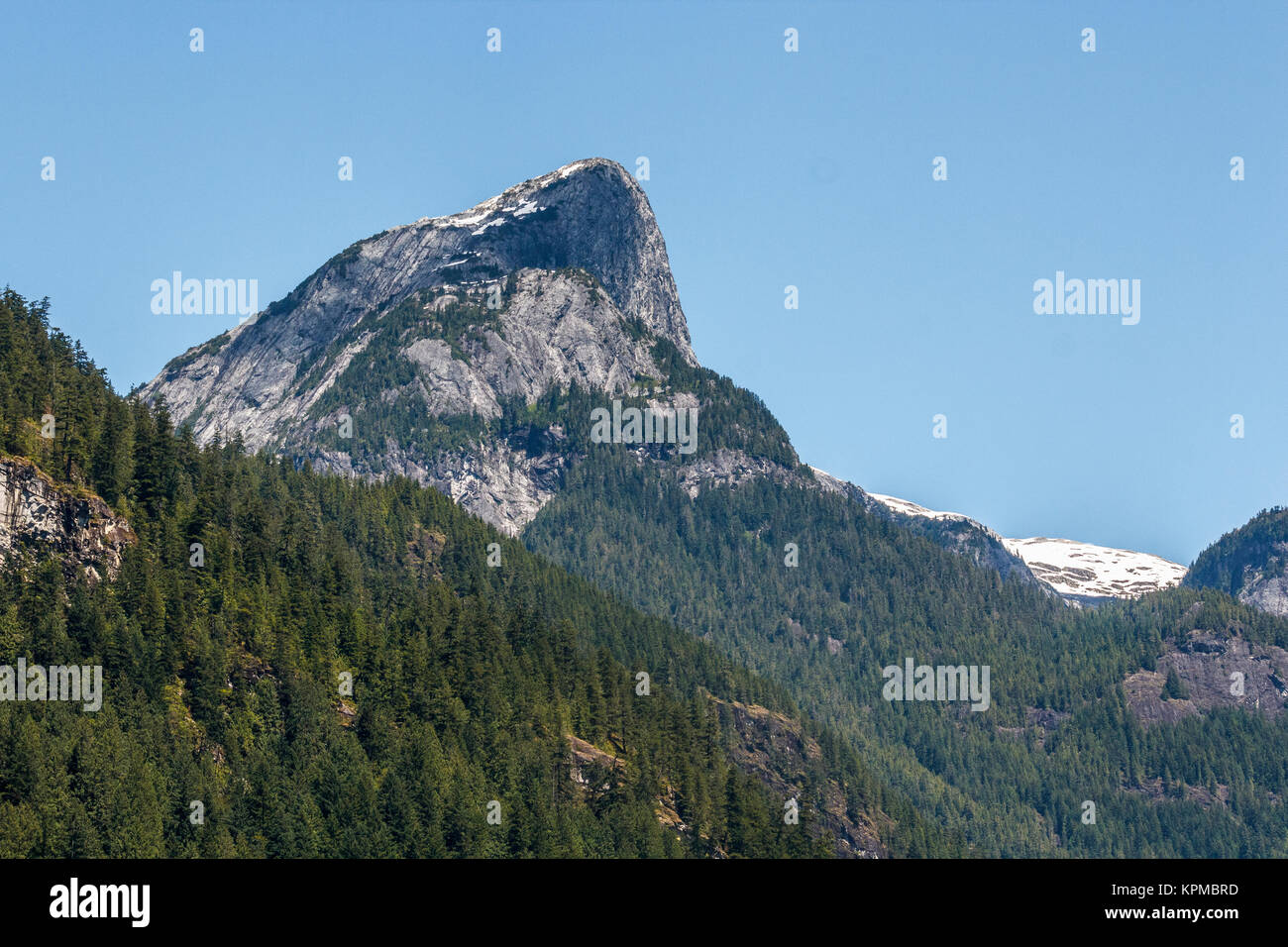 British Columbia's Princess Louisa Inlet is surrounded by glaciers and high, rugged peaks of the Coast Mountains, including this sheer granite face. Stock Photo