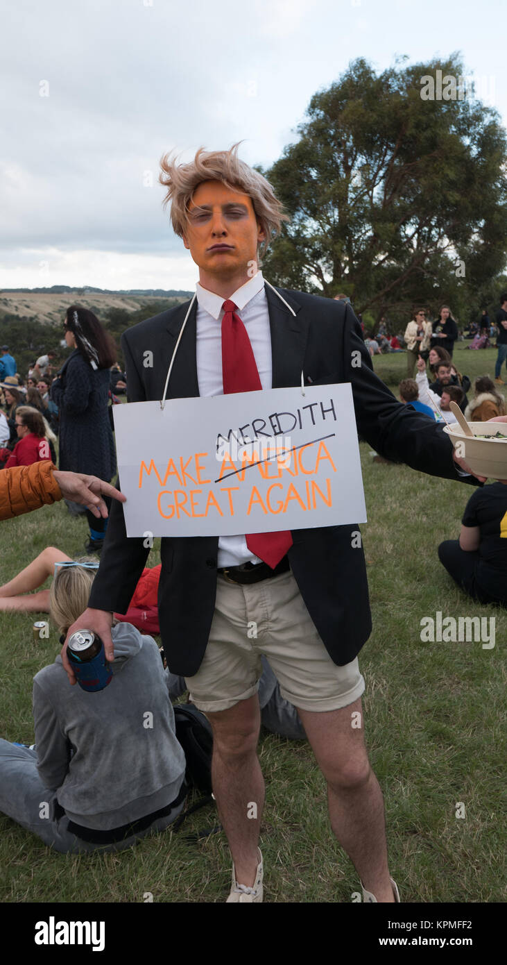 Young man with orange face blonde wig dressed as donald trump Donald Trump wearing a sign saying Make Meredith Australia great again. Stock Photo