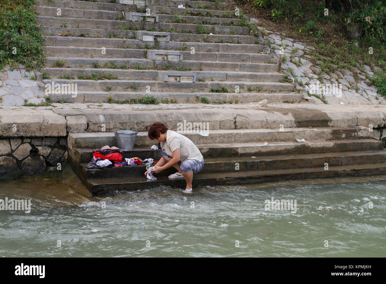 Washing clothes by the river bank of Li River in GUilin, China. Stock Photo