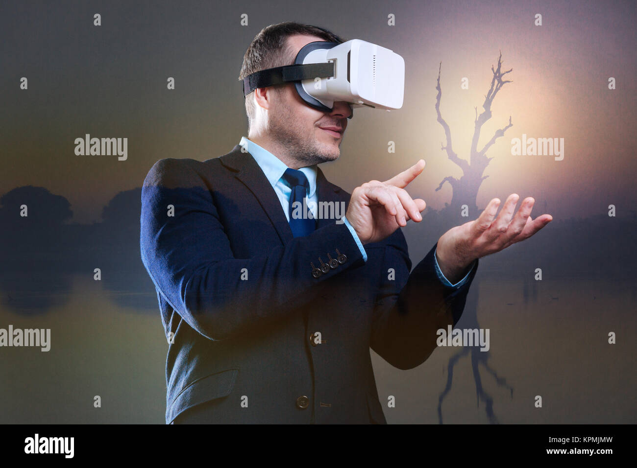 Joyful businessman wearing virtual reality goggles Stock Photo - Alamy