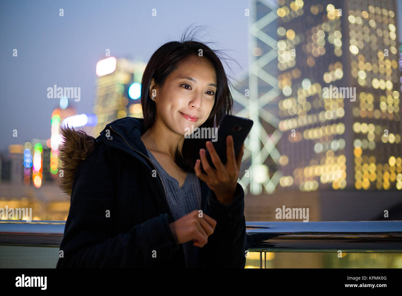 Woman use of cellphone at Hong Kong Stock Photo - Alamy