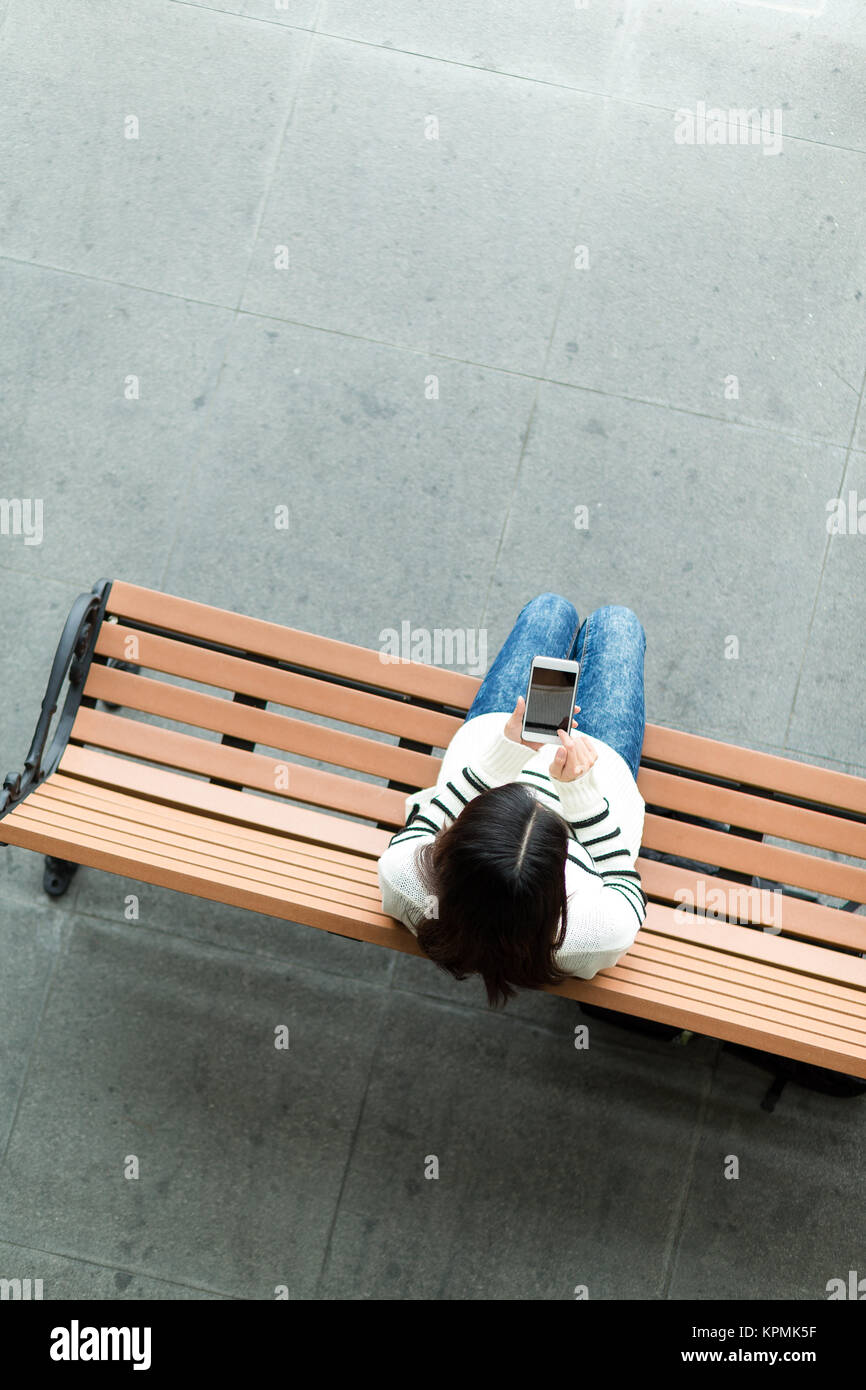 Using Phone Top View Top view of woman use of cellphone Stock Photo - Alamy