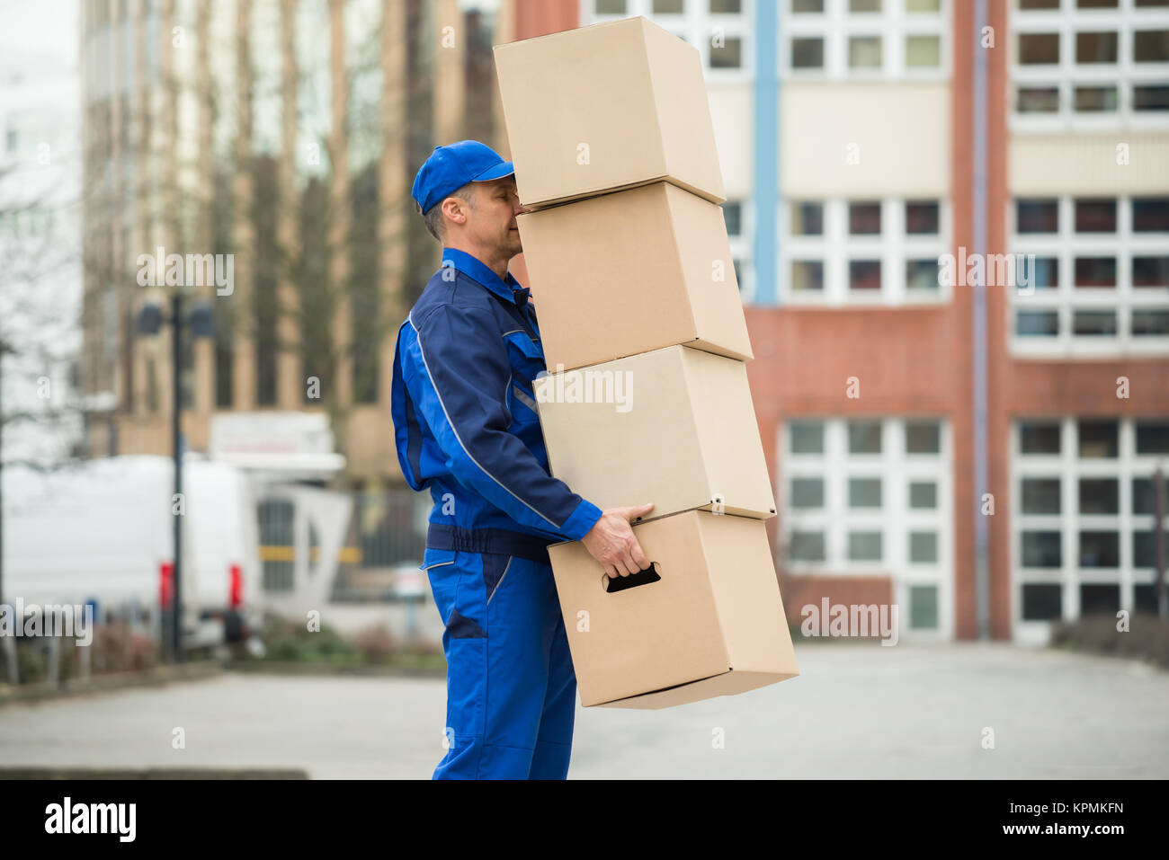 Delivery Man Balancing Stack Of Boxes Stock Photo - Alamy