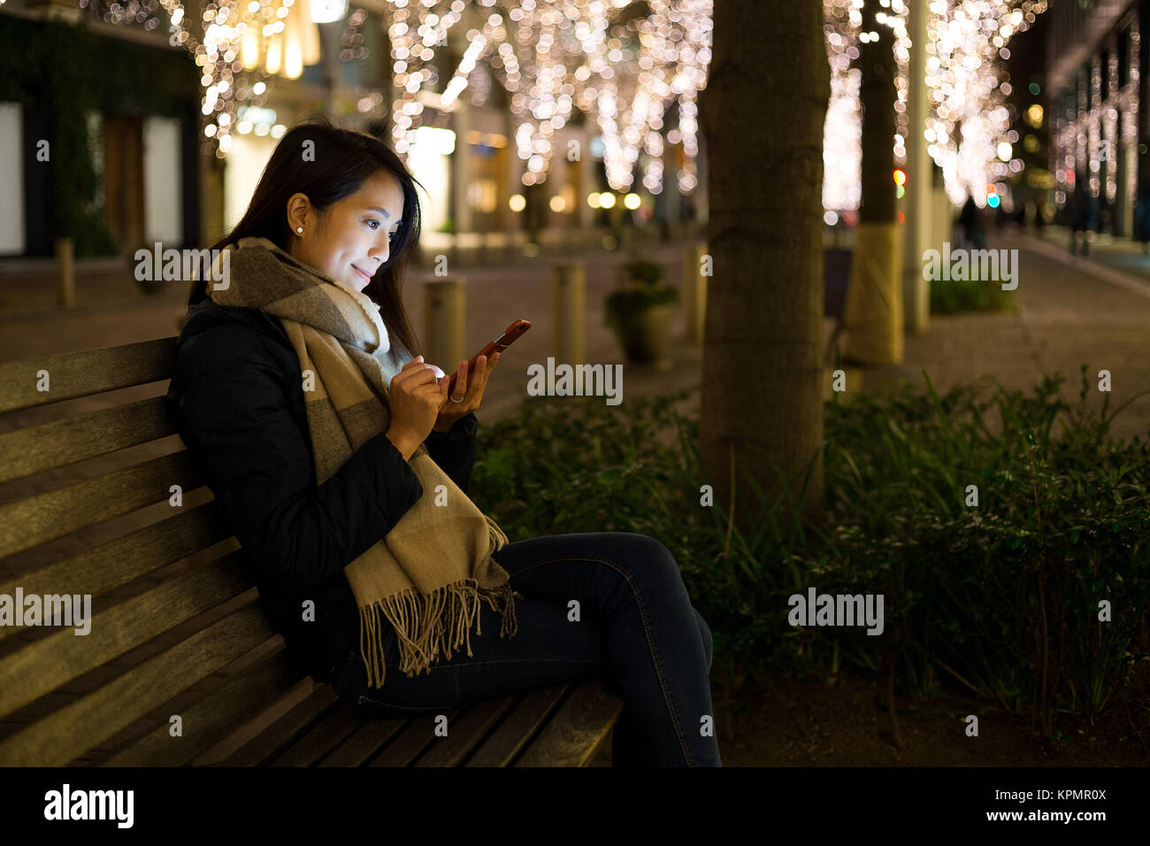 Woman use of mobile phone at night Stock Photo - Alamy
