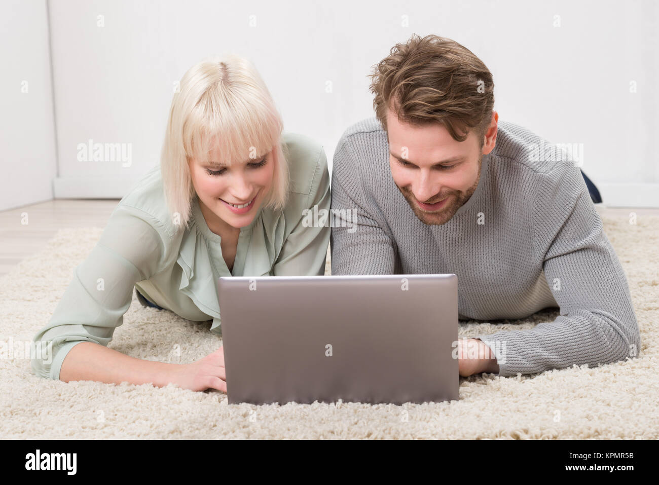 Happy Couple Using Laptop Together Stock Photo - Alamy