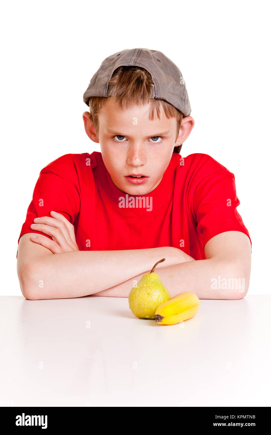 Defiant young boy glowering at the camera Stock Photo