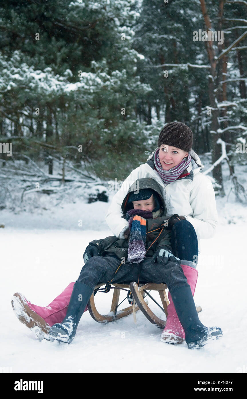 Boy and girl on a sled Stock Photo