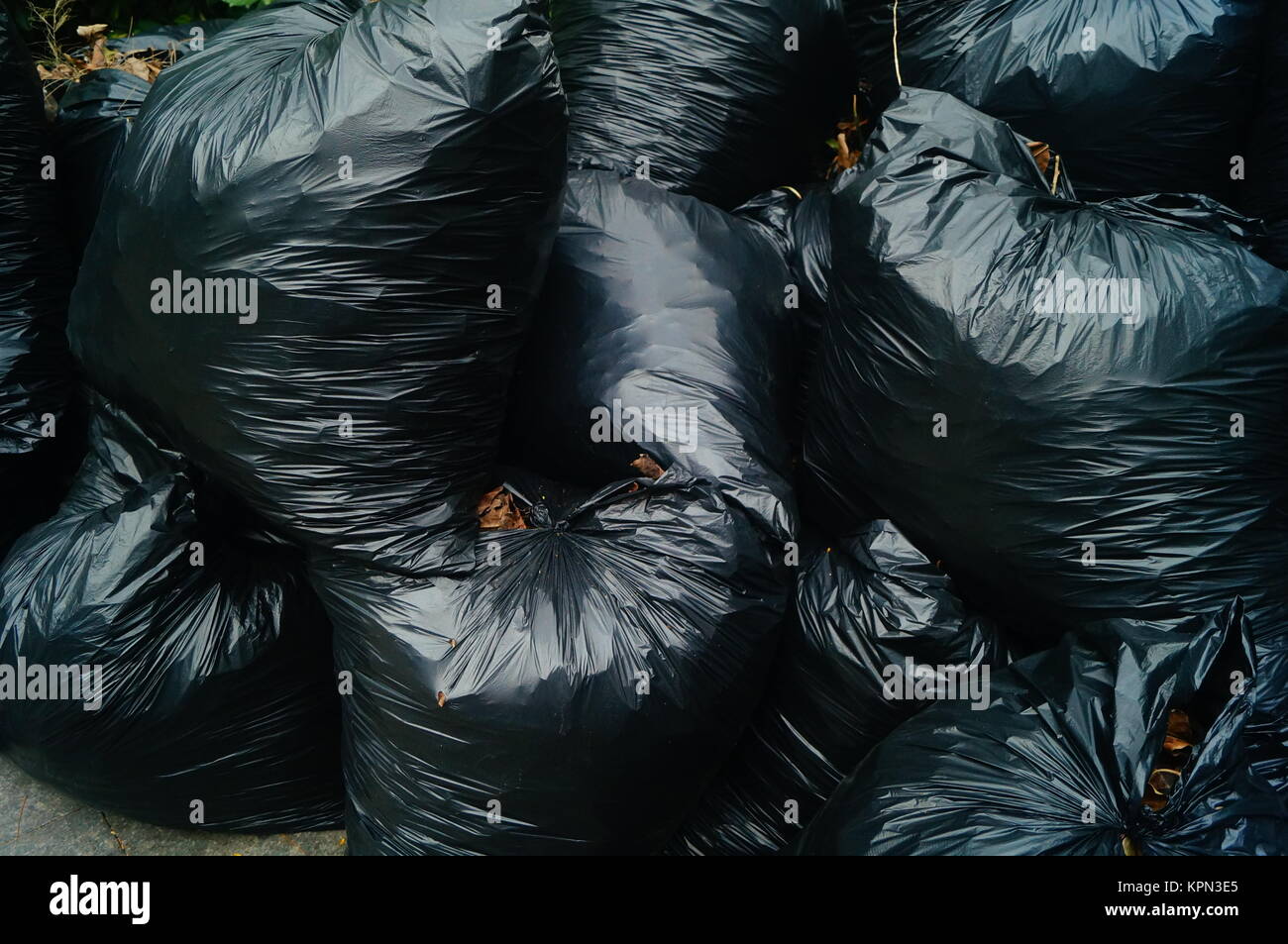 Black plastic bags filled with garbage, heaps of heaps, on the city ...