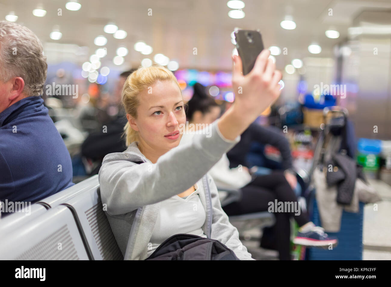 Female traveler taking selfie on airport Stock Photo - Alamy