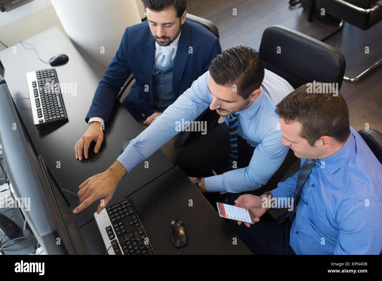 Business team analyzing data on computer Stock Photo - Alamy