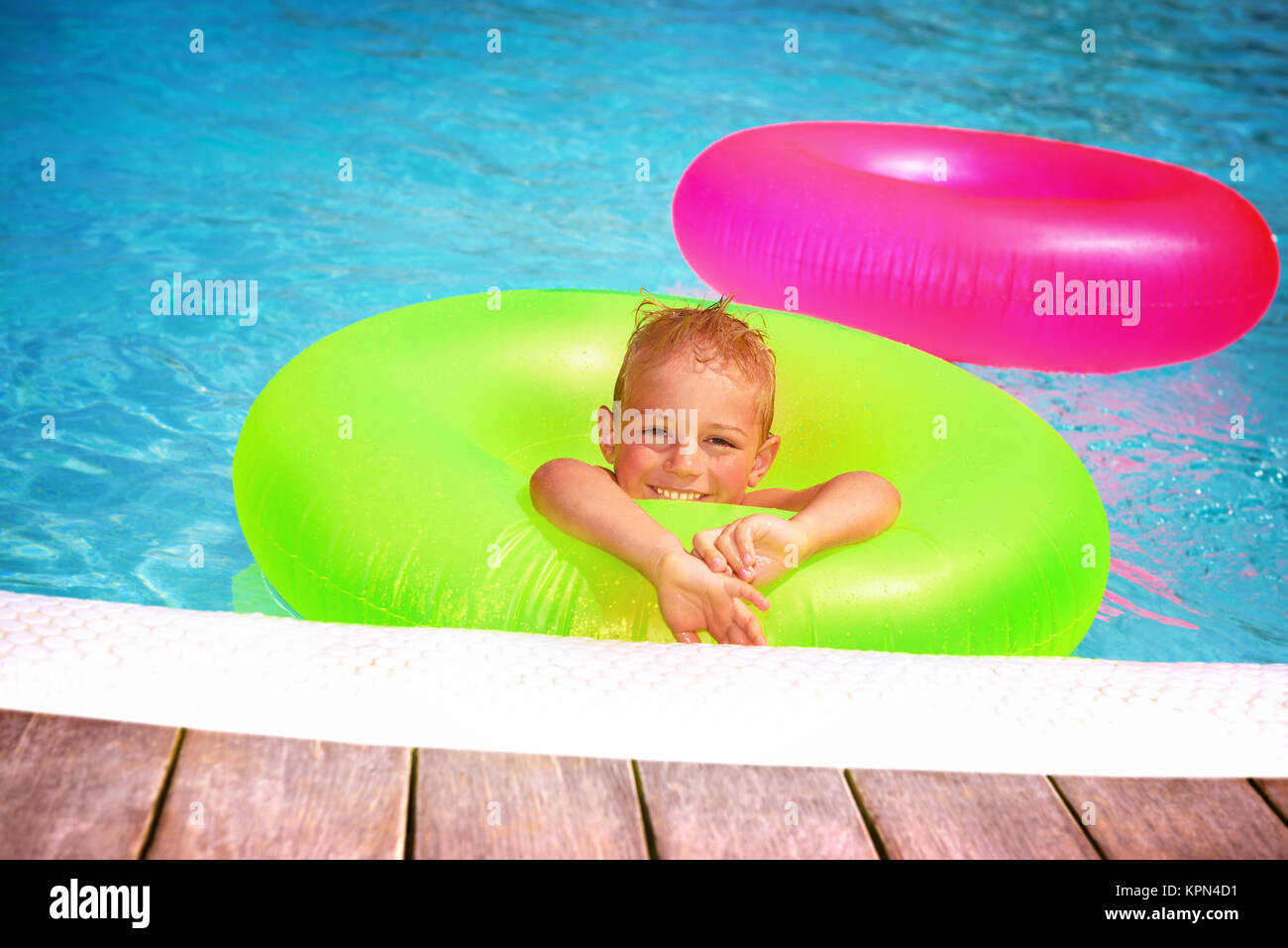 Boy floating in pool hi-res stock photography and images - Alamy