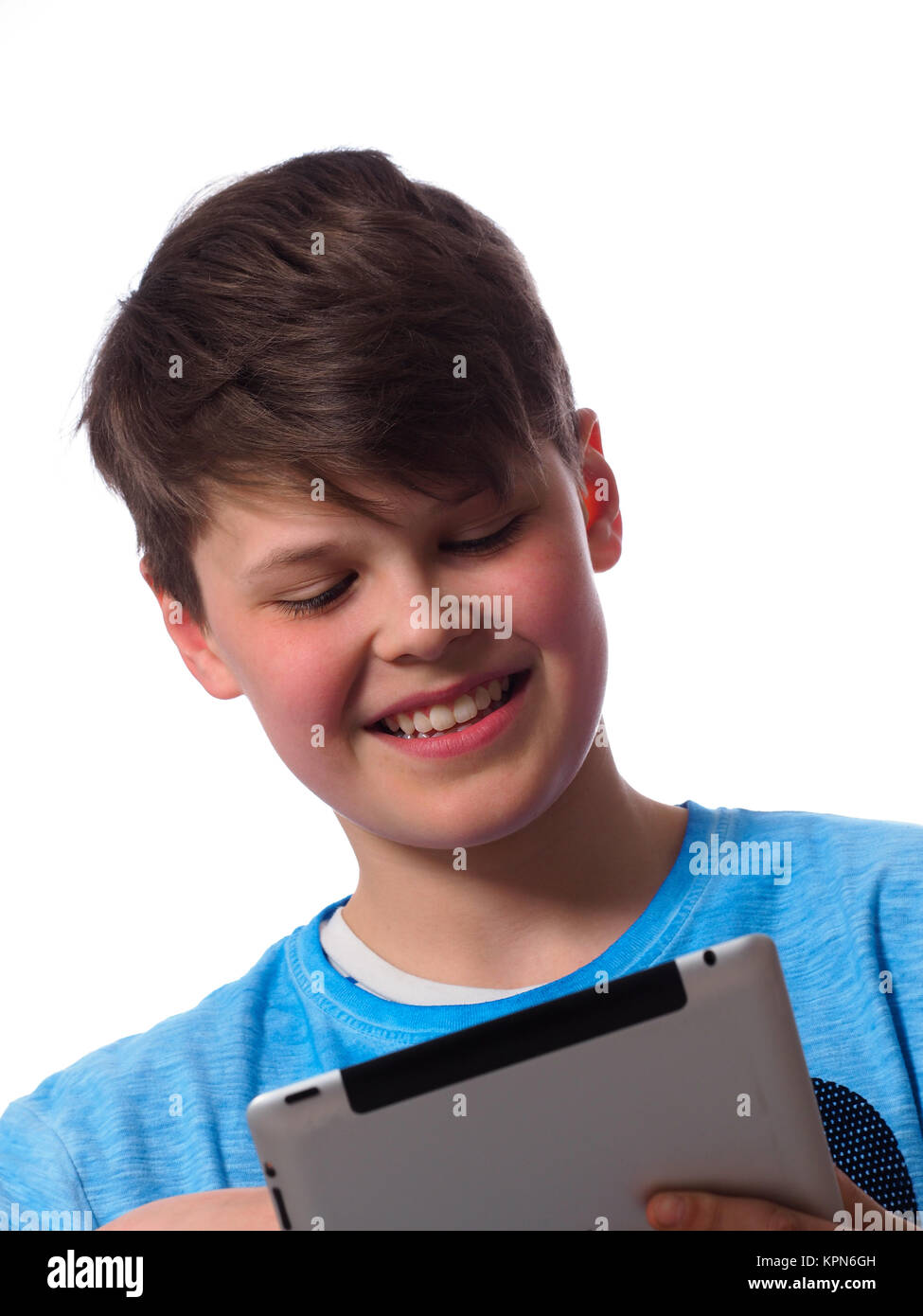 Young boy using a tablet computer on a white background Stock Photo - Alamy