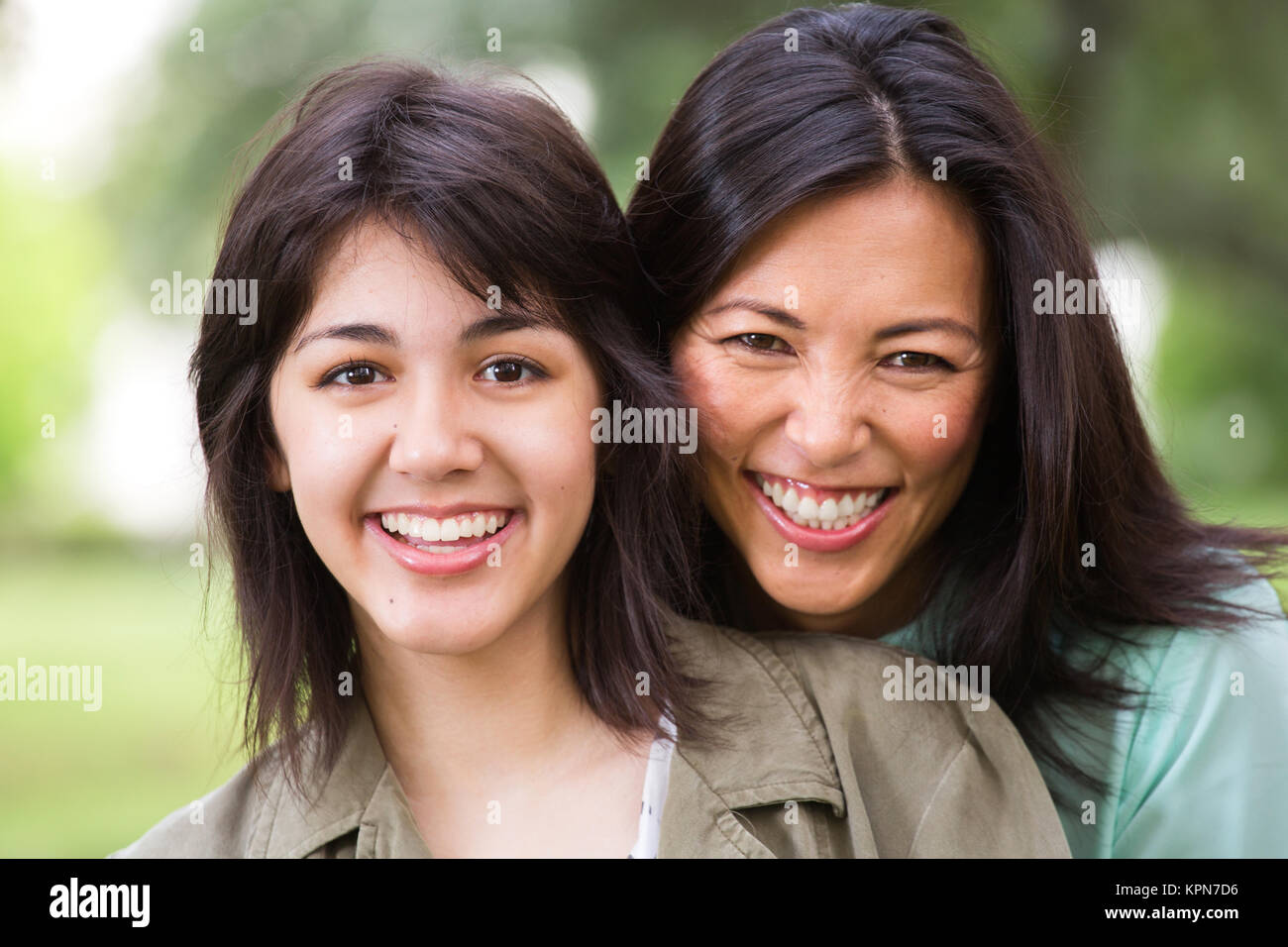 Asian mother laughing and huging her child. Stock Photo