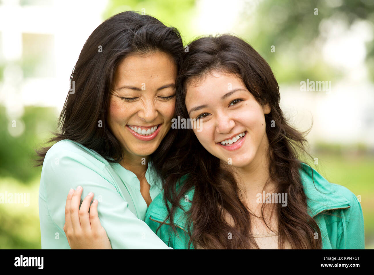 Asian mother laughing and huging her child. Stock Photo