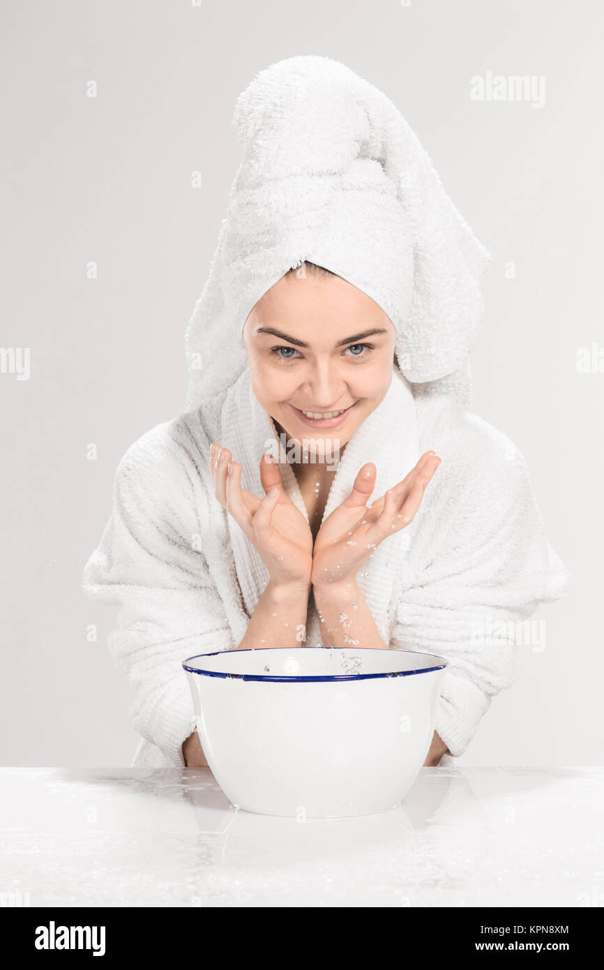 Young woman washing face with clean water Stock Photo Alamy