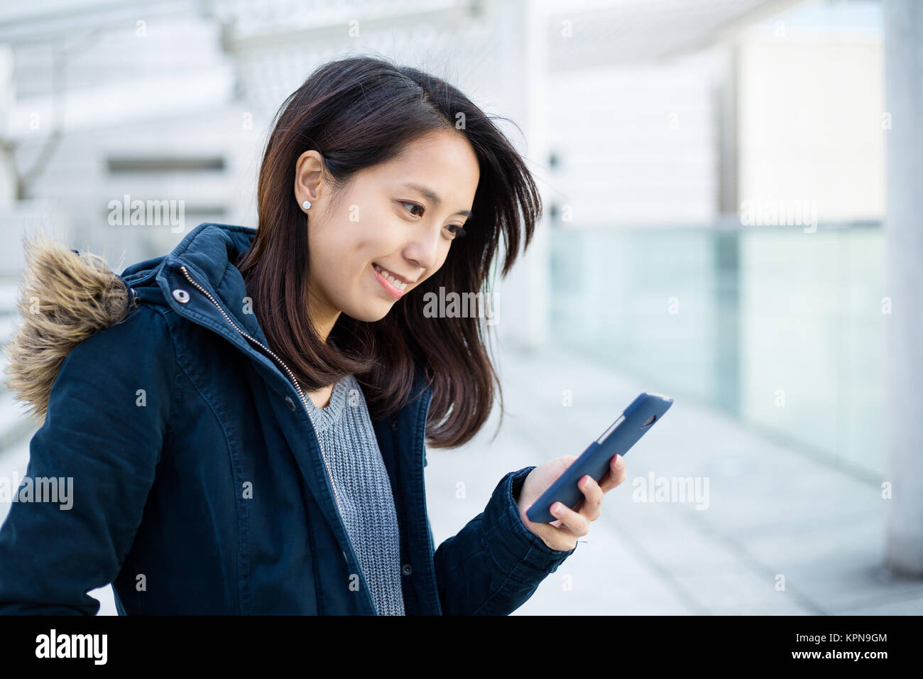 Woman use of mobile phone in Hong Kong city Stock Photo - Alamy