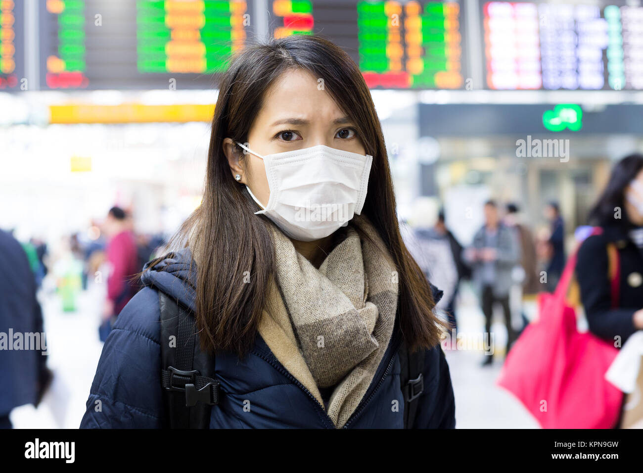 Woman wearing medical face mask in train station Stock Photo - Alamy