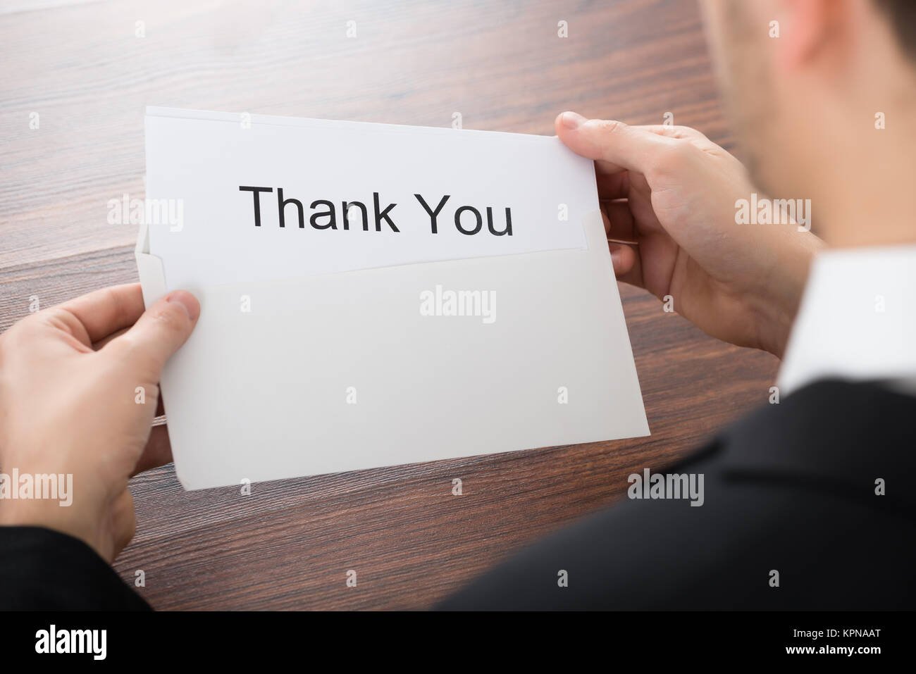 Businessman Holding Thank You Card In Envelope Stock Photo Alamy