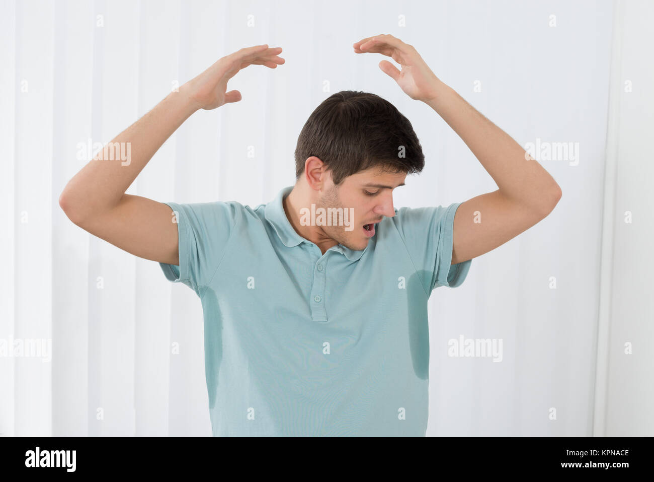 Man Sweating Very Badly Under Armpit Stock Photo