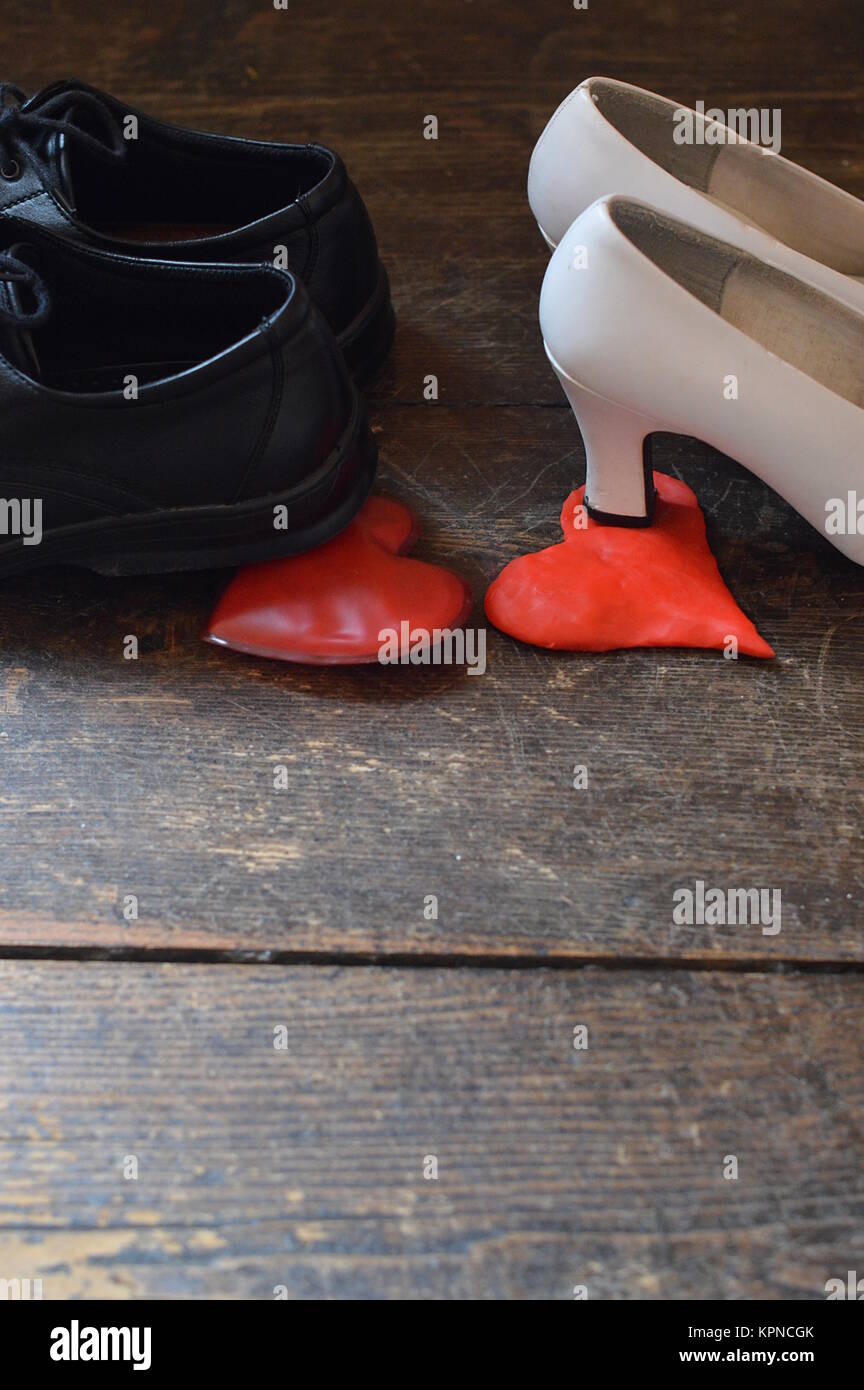 shoes of man and woman step on heart Stock Photo