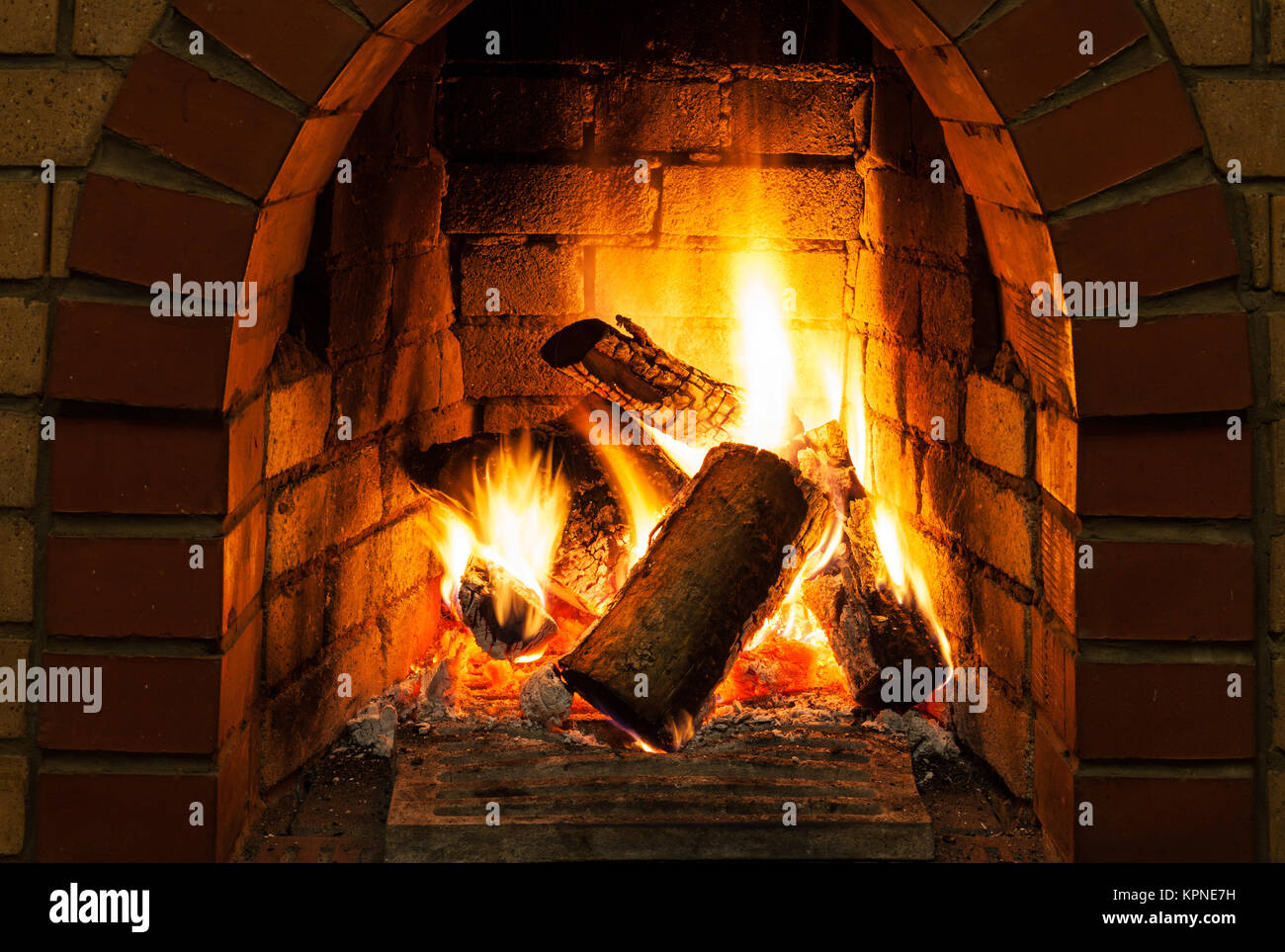 burning billets in fire-box of fireplace Stock Photo