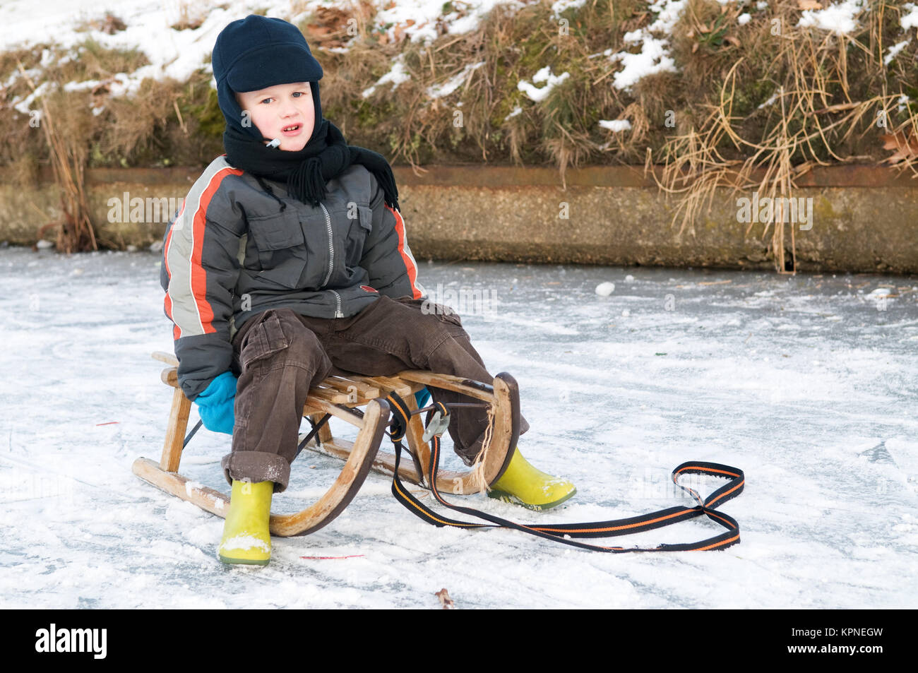 Boy On A Sleigh Stock Photo Alamy