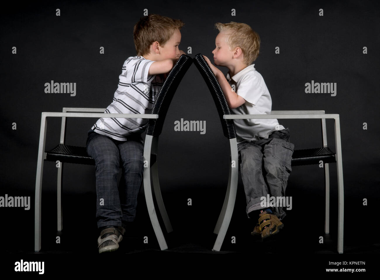 Two Brothers On A Chair Stock Photo