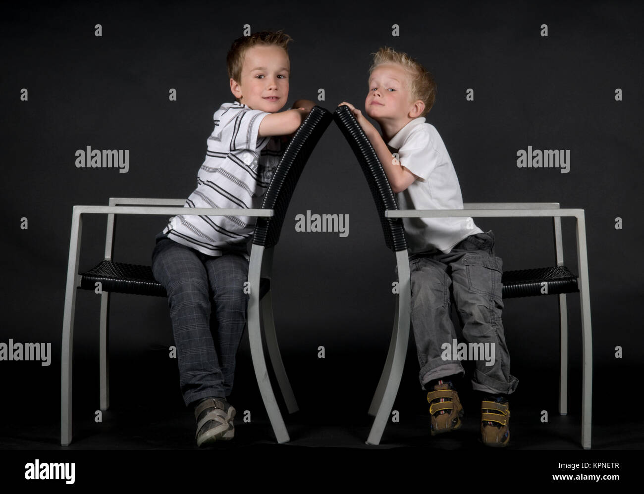 Two Brothers On A Chair Stock Photo
